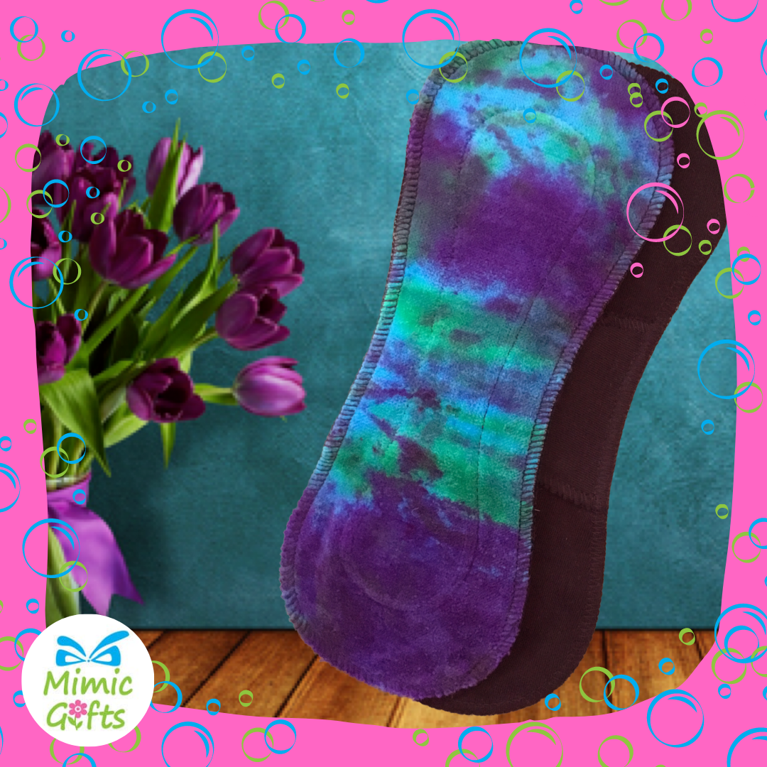 Purple, blue & green cloth sanitary towel which can be washed and reused for a zero waste lifestyle
