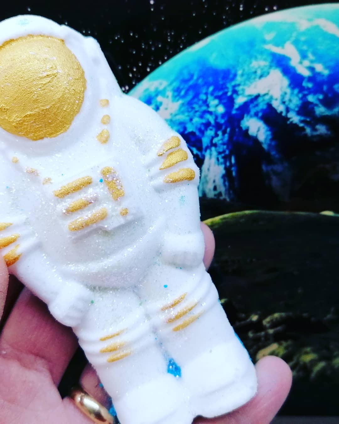 White & Gold vegan bath bomb in shape of a spaceman with hidden colours