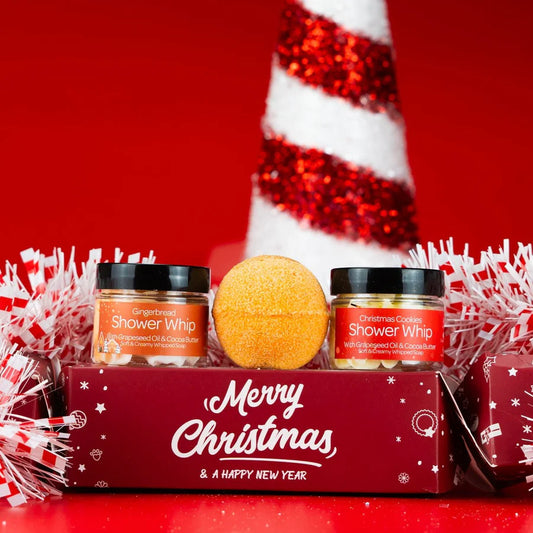 Festive setting showing cracker containing bath shower pamper gift set