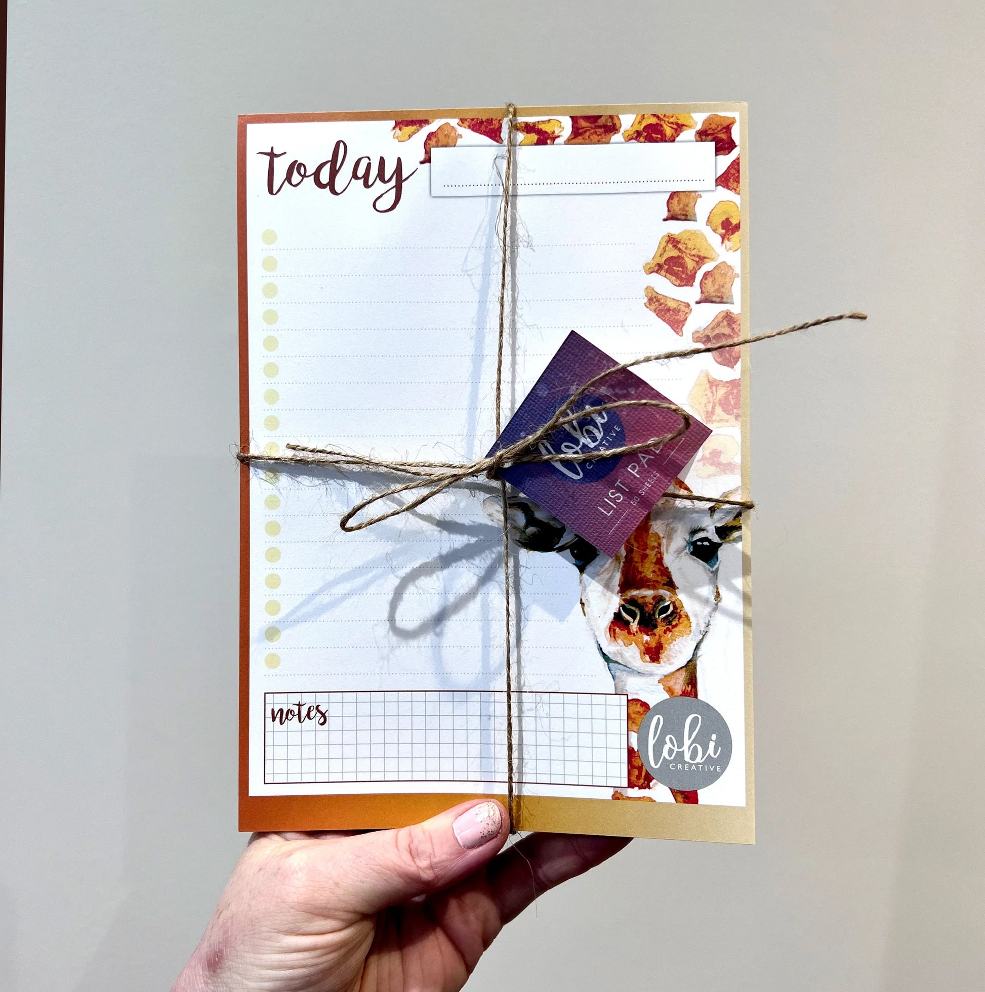 Eco friendly notepad for everyday task lists with artists drawing of giraffe on the right hand side of page