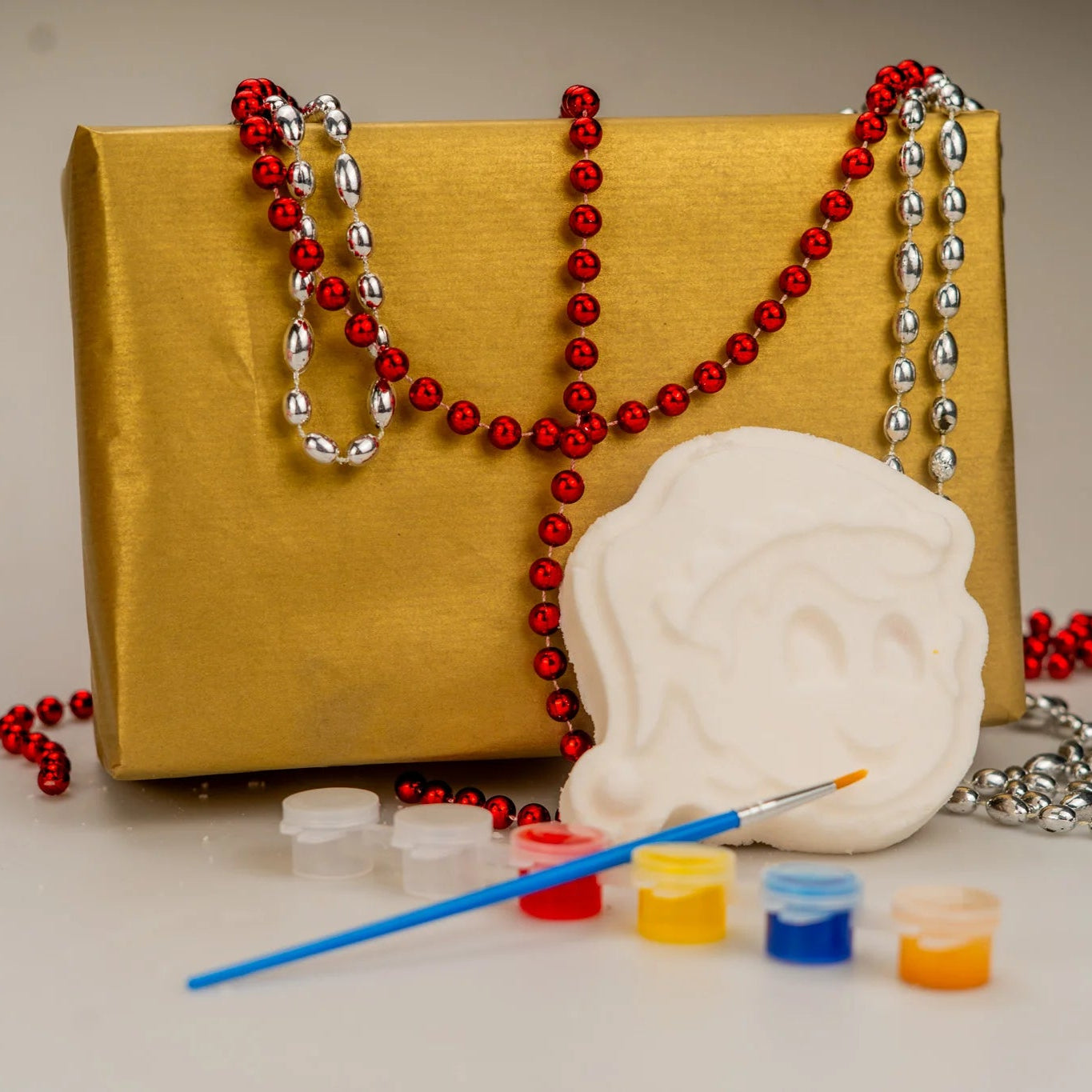 A gift wrapped festive kit containing a bath bomb and paints set, so you can paint your own bath bomb this Christmas